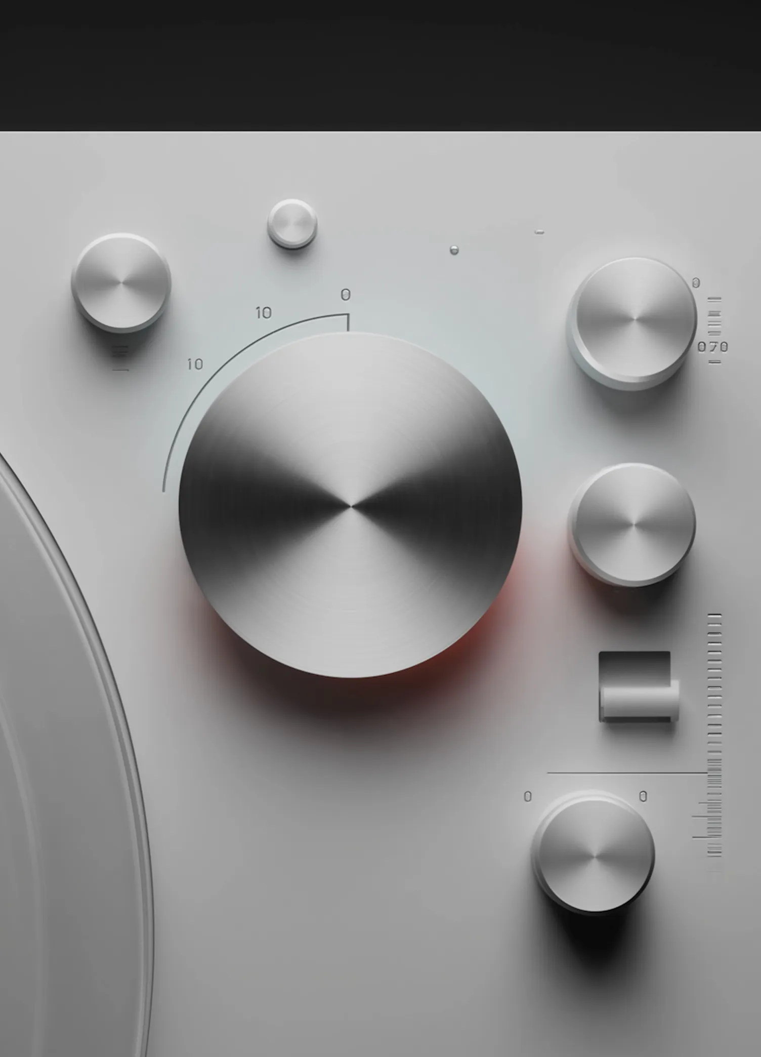 Close-up of silver brushed metal control knobs on a modern audio device with a large central dial.